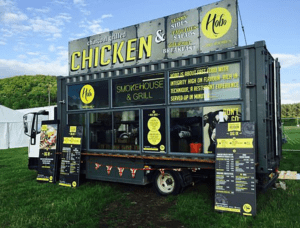A vibrant and colorful food truck created from a cargo container, showcasing its customizability and mobility.